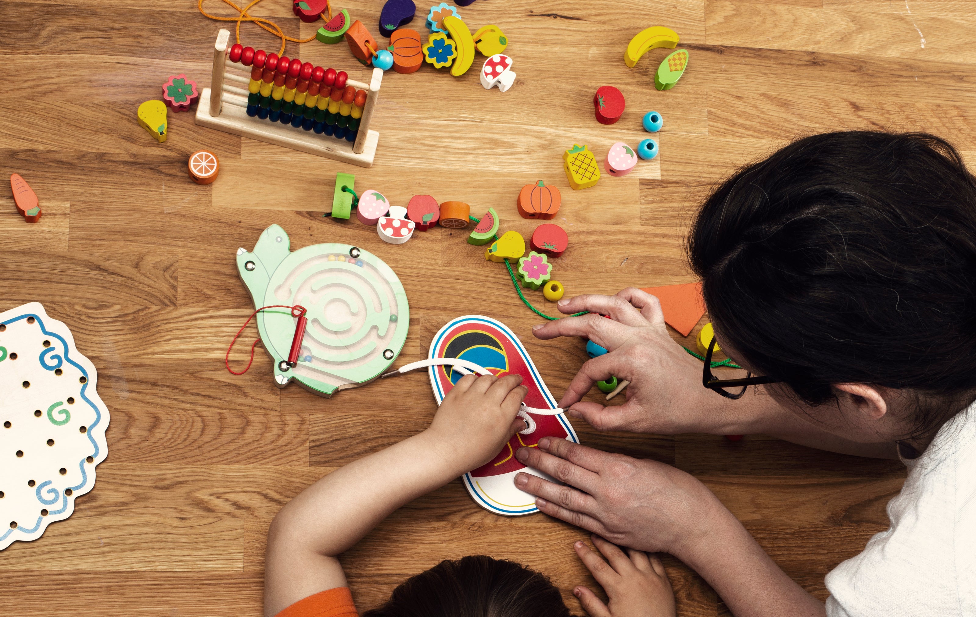 Teacher and Toddler play with montessori toy. GadWitch Toy Store