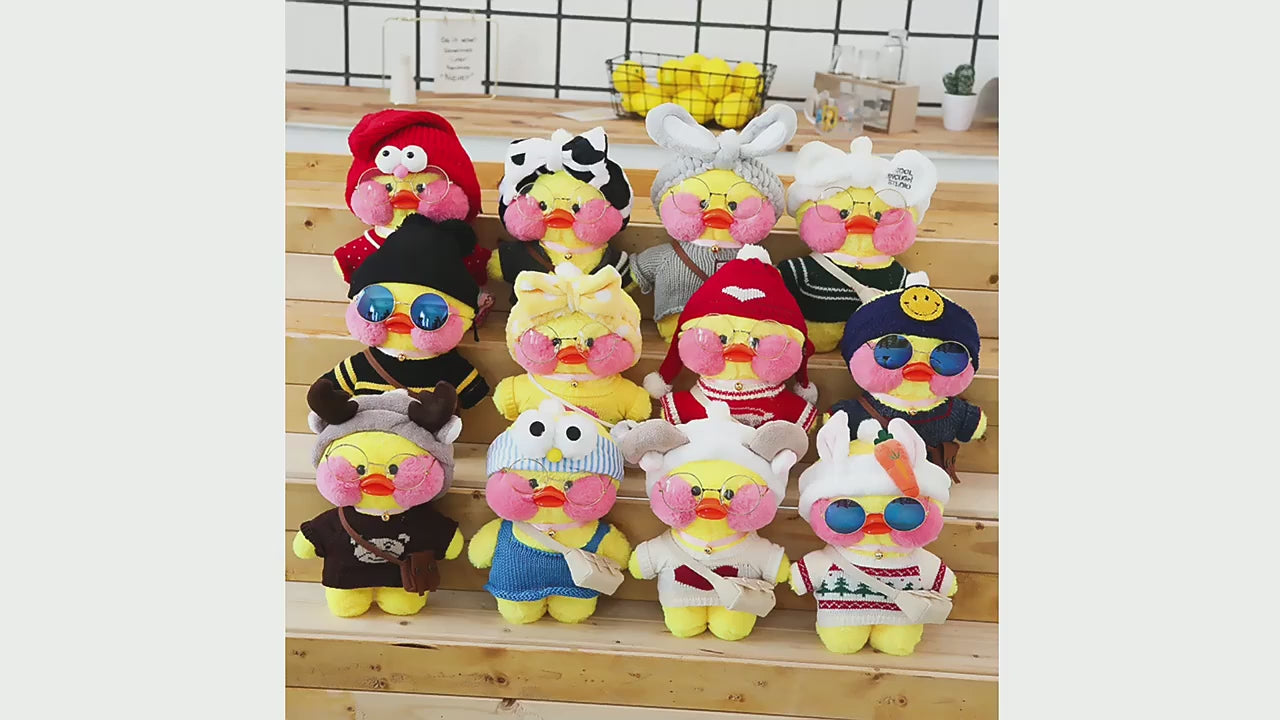 Load video: A video showcasing the Kawaii Lalafanfan Duck Plush being dressed in different outfits, highlighting its soft texture, trendy accessories, and playful versatility for kids and collectors.